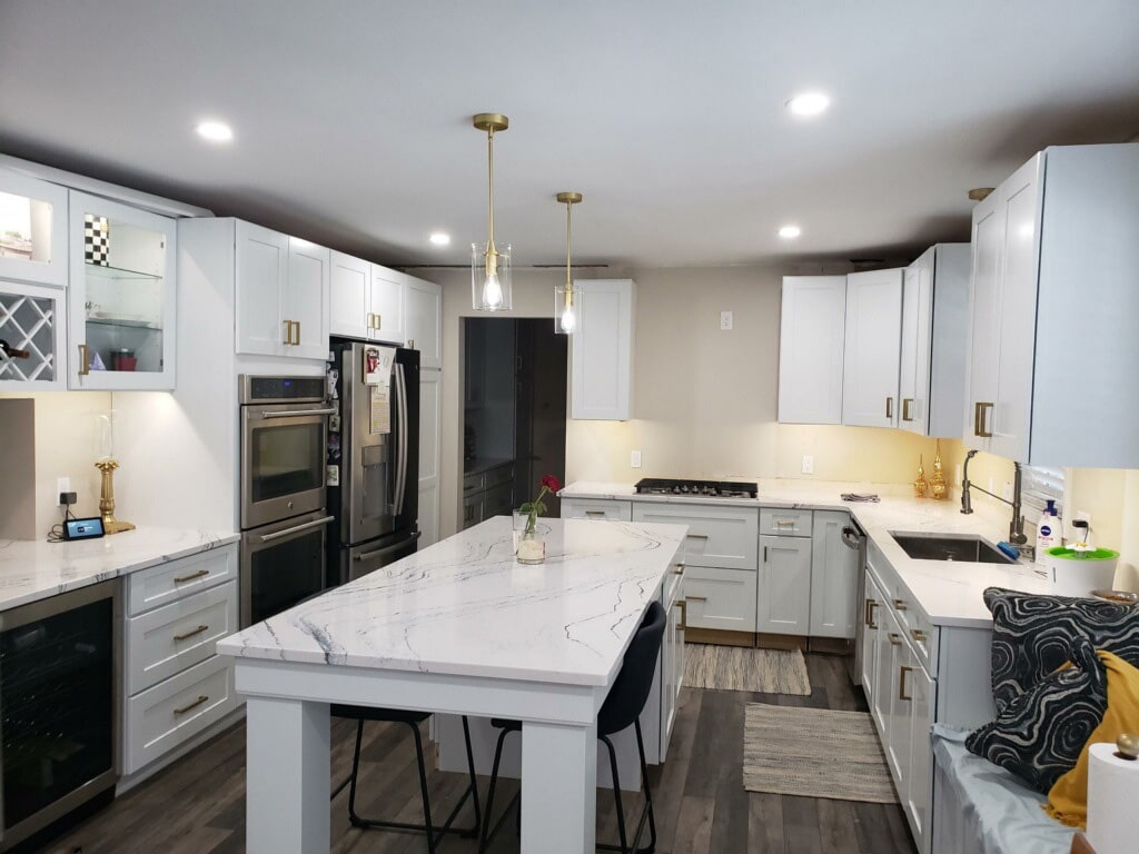 residential kitchen with special light fixtures installed over the island